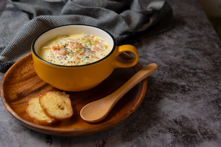 Chowder soup on a plate and a wooden spoon