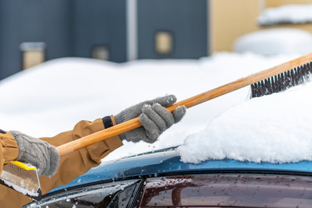 Snow piled up on the car and taken down with a snow brush.の写真素材