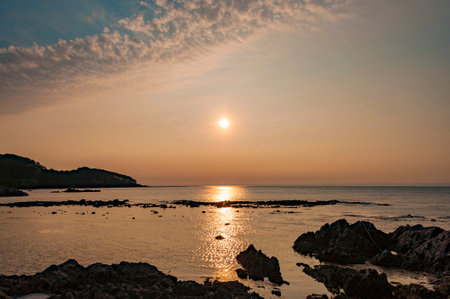 Sunset over the sea in the evening. Beautiful seascape. Sunset at Okazaki Coast, Fukaura, Aomori,...