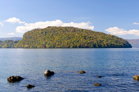 Autumn scenery with lake and mountains. View from the lakeshore. Lake Towada, Ogura Peninsula, Aomori, Japan.の写真素材