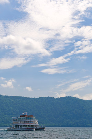A view of Lake Towada with a sightseeing boat. Aomori, Japanの写真素材