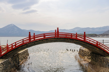 Red Drum Bridge at Sanzu River, Osorezan, Aomoriの写真素材