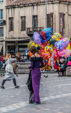 A young woman selling balloons at the centre of Athens Greece, in Monastiraki.のeditorial素材
