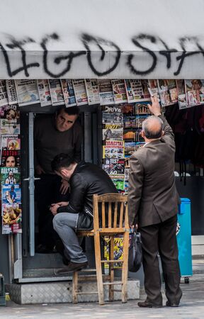 Newspaper stand, Monastiraki, Atyhens, Greece with people buying or selling newspapers at a traditional Greek kioskのeditorial素材