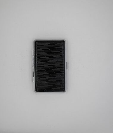 Black cigarette case isolated closed metallic and shine in limbo backroundの写真素材