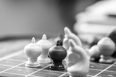 Single white pawn on a chess board surrounded by a numberの写真素材