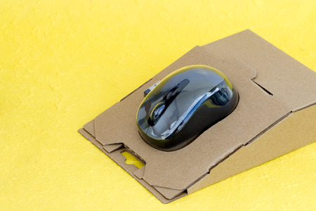 wireless mouse with pack on yellow backgroundの写真素材