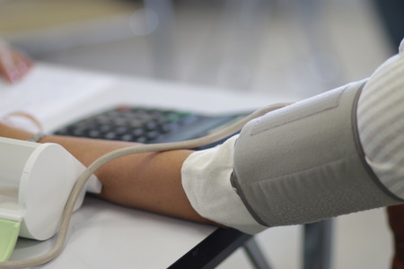 Measuring the blood pressure with pressureの写真素材