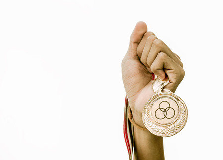 medal golden in hand man isolated on whiteの写真素材