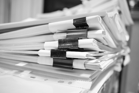 Paper stack, Pile of unfinished documents on office desk related to business functions. Stack of business papers for Annual Report files, Document is written,drawn,presented. Business offices concept.の写真素材