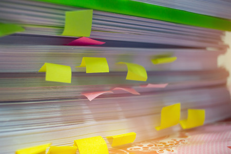 Paper stack, Pile of unfinished documents with post it on office desk related to business functions....