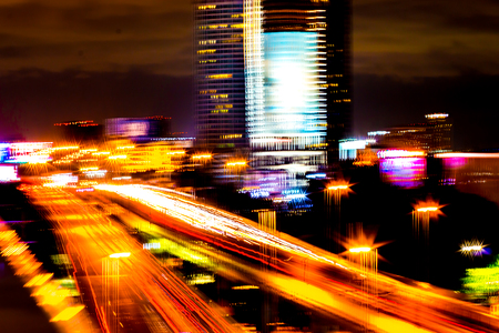 Colorful of city modern buildings night and road light abstract background, decorated with de-focus...