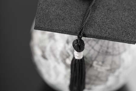 Graduate study abroad concept, Graduation cap on top Earth globe model map on laptop with Radar...