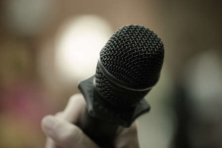 Microphones in seminar room, talking speech in conference hall light with microphone and keynote. Speech is vocalized form of communication humans, Blurred of audience in meeting room, vintage toneの写真素材