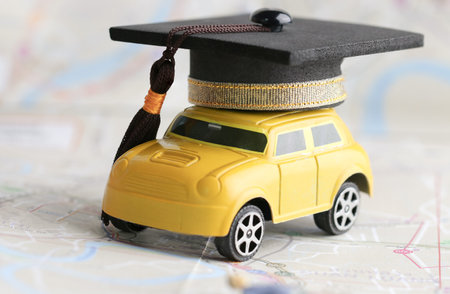 Graduate study abroad inter school concept : Graduation cap over yellow car on Bangkok city map, road to succes in life. Mortarboard Graduate learning program, Education and back to school conceptの写真素材