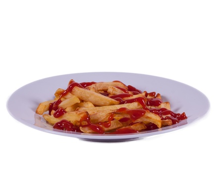 A plate of chips/fries with tomatoe sauce/ketchupの写真素材