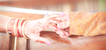 newlywed hands with mehendi and braceletsの写真素材