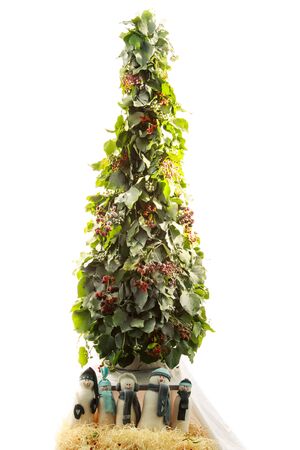 snowman handmade toy under the design green New Year tree isolated on white backgroundの写真素材