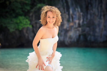 beautiful blonde bride stand near blue sea water on island beach Thailandの写真素材