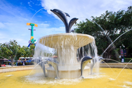 round fountain with dolphin sculptures in tourist park in Vietnamの写真素材