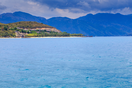 panorama of clouds lace in blue sky above azure sea green hillの写真素材
