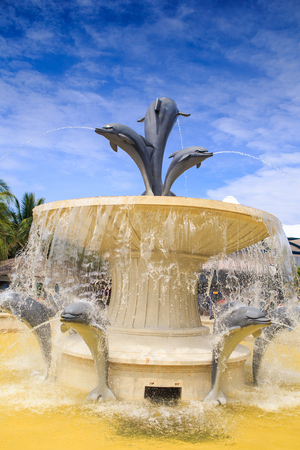 round fountain with dolphin sculptures in tourist park in Vietnamの写真素材