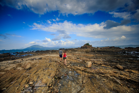 backside view distant guy blonde girls in vest shortsの写真素材