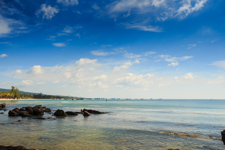 different rocks in the transparent shallow water near the coastの写真素材