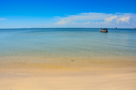 shallow clear sea by golden sand beachの写真素材