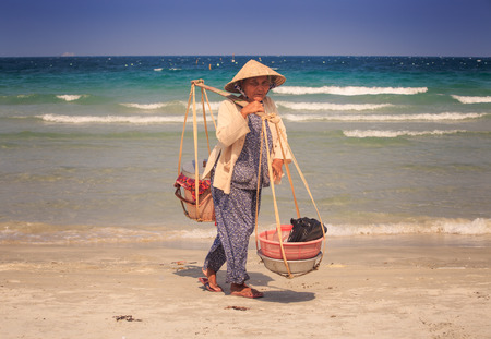 NHA TRANG / VIETNAM - APRIL 16 2017: Close up of a young woman in a hat on a yoke with a rocket on a beach in Nha Trangのeditorial素材