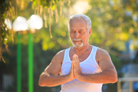 closeup gray bearded old man in white vestの写真素材