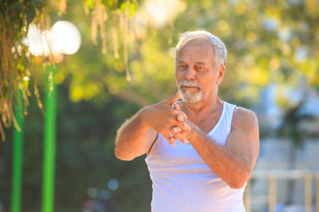 closeup of gray bearded old man in whiteの写真素材