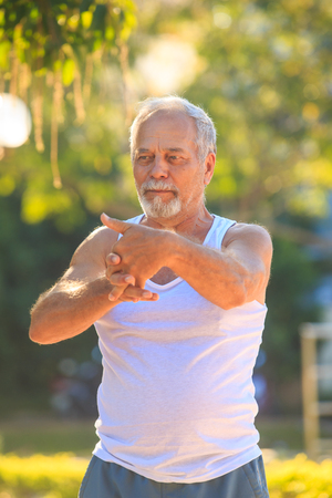 closeup european gray bearded old man in whiteの写真素材
