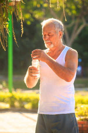 closeup european gray bearded old man in white vestの写真素材
