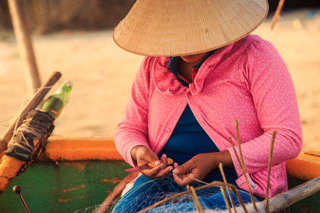 closeup Vietnamese woman in national straw hat and pink blouseの写真素材