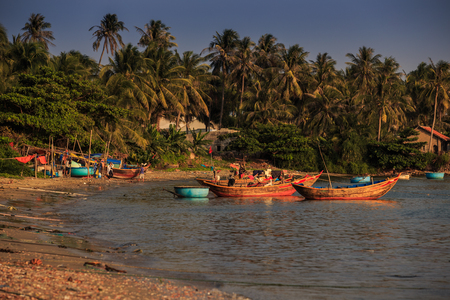 colourful Vietnamese round and long fishing boats in azureのeditorial素材