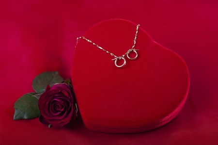heart shaped box with jewelry and flowerの写真素材