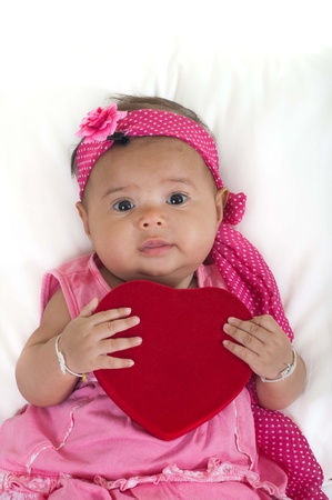 Baby with red heartの写真素材