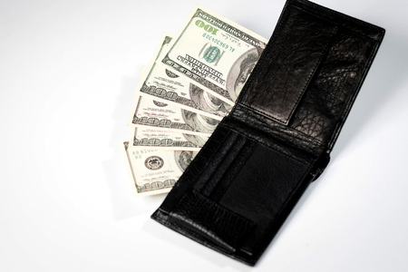 dollar bills in a black mens wallet on a white background and a passport of the Russian Federationの写真素材
