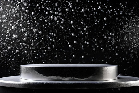 Podium on black background with silver paint drops.の素材