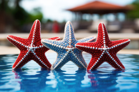 Patriotic Poolside: A Trio of Starfish Embracing the Red, White, and Blueの素材