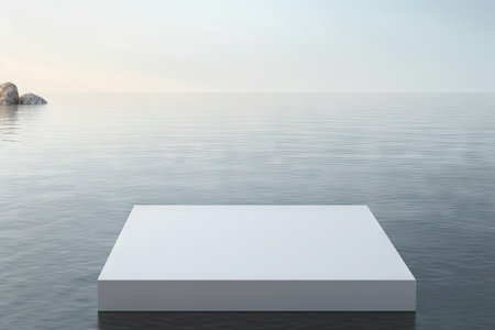 A white square podium is placed on a background of water surface, creating a flat lay image. There iの素材
