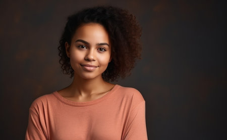 portrait of beautiful positive african american woman standing with arms crossedの素材