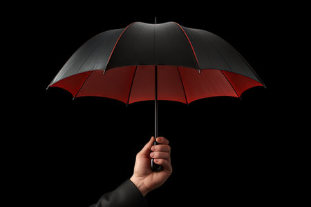 A red 3D umbrella icon isolated on black backgroundの素材