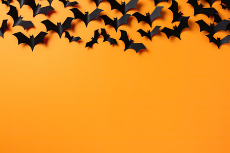 Halloween card with bats on orange background Congratulatory or invitation banner Top view with spacの素材