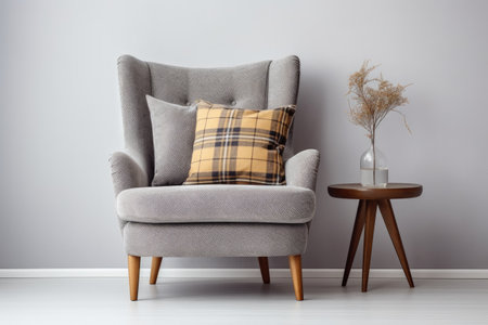 Modern armchair with cushion and checkered pattern adjacent to white wall blank area for text Decorの素材