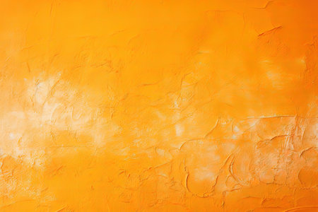 Copy space on a bright painted orange stucco wall with abstract background textureの素材