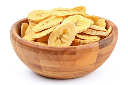 Top down view of dried banana chips in a wooden bowl on a white backgroundの素材