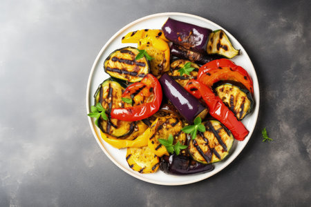 Vegetable plate with bell pepper zucchini and eggplant on a light background Top view with space forの素材