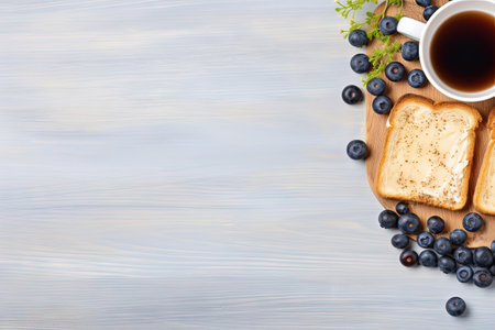 Text space for buttered toasts blueberries and coffee on grey table Flat layの素材